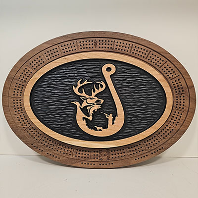 Oval wooden cribbage board with a carved hook design, featuring wildlife silhouettes inside, bordered by peg holes.