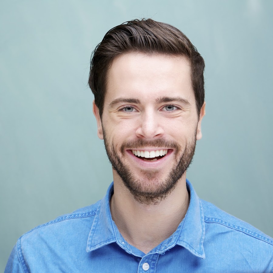 Portrait of a handsome young man with beard smiling